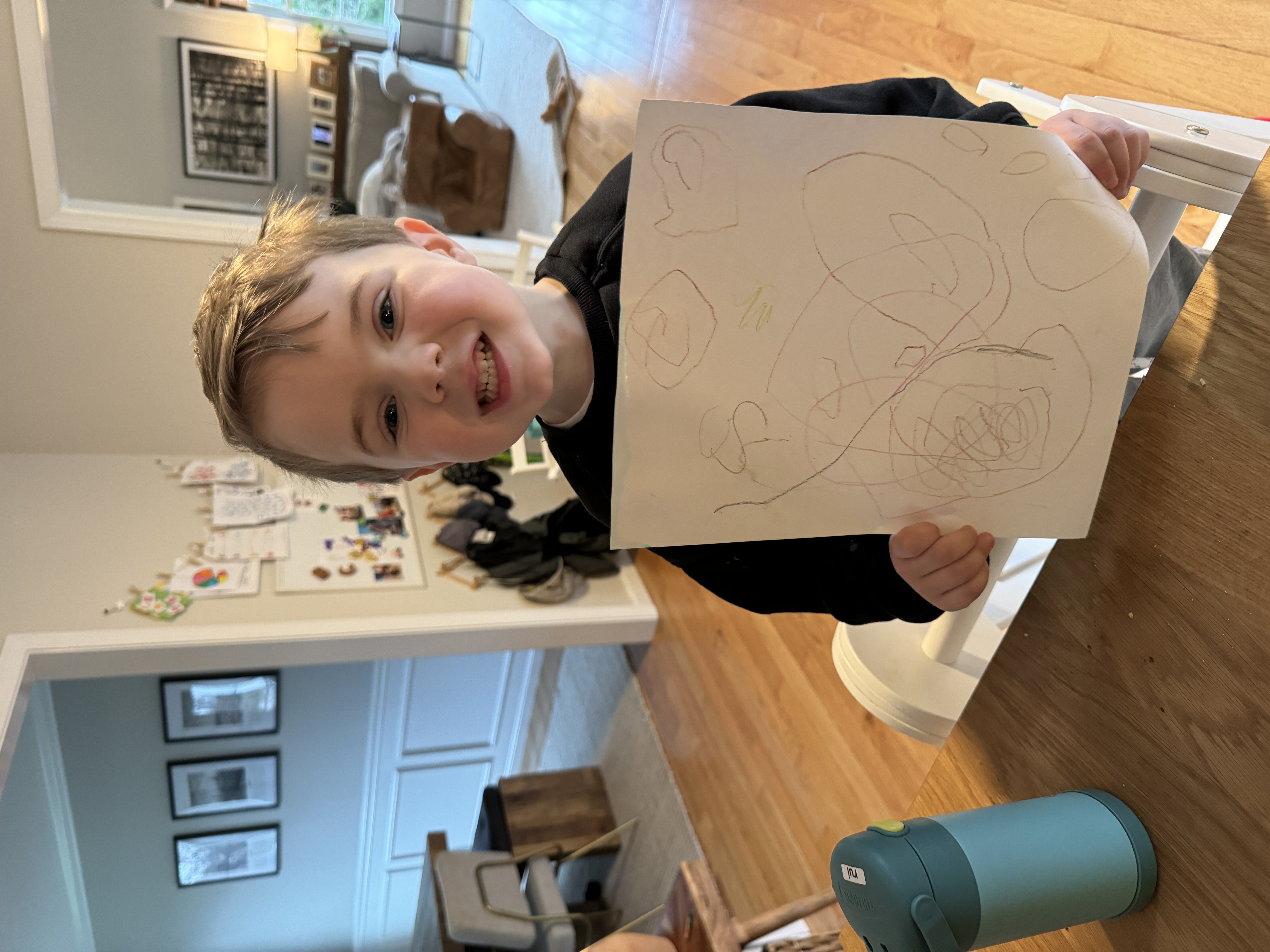 RA Lourenço demonstrating holding up his artwork and smiling
